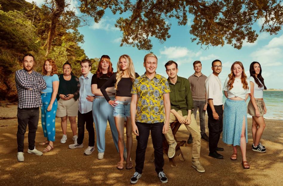 Cast of the Channel 4 show "The Virgin Island" posing on a beach.