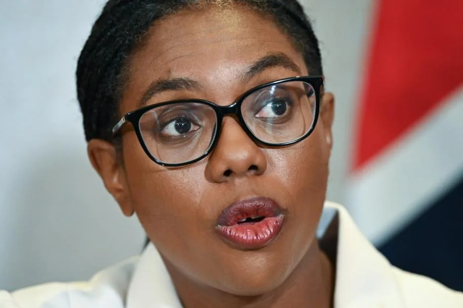 Kemi Badenoch, a Black woman wearing glasses, speaks during a press conference on early prison releases.