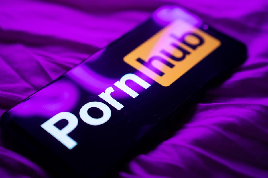 Mobile phone displaying the Pornhub logo on its screen.