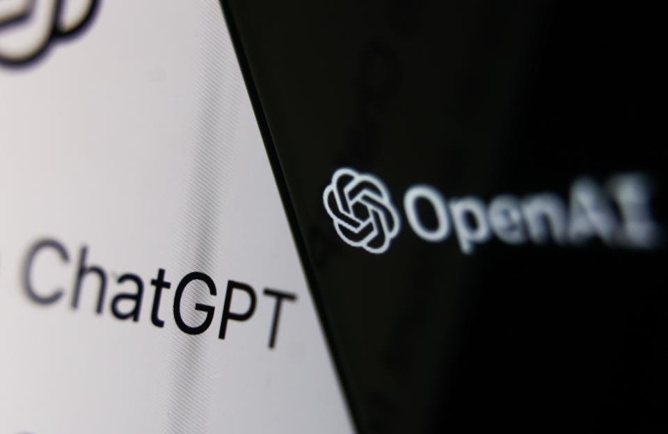 Illustration of the OpenAI logo on a phone screen and the ChatGPT website on a laptop screen.