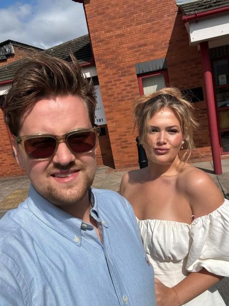 Poppy O'Toole and her husband smiling for a selfie.