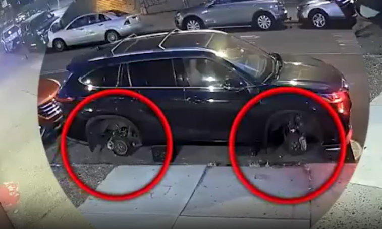 A dark car missing its front and back left tires, circled in red, suggesting theft.
