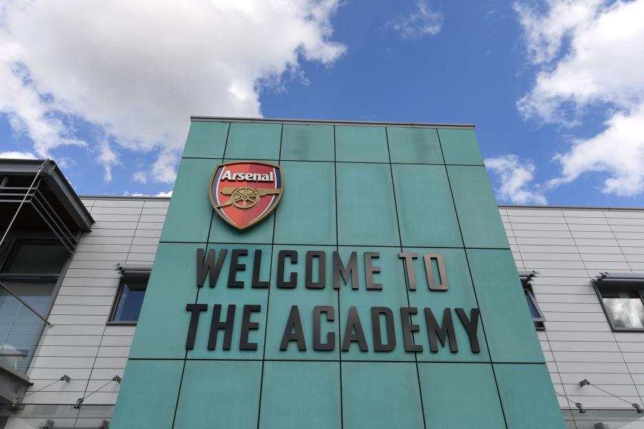 The entrance to the Arsenal Academy with "WELCOME TO THE ACADEMY" in black letters and the Arsenal crest.