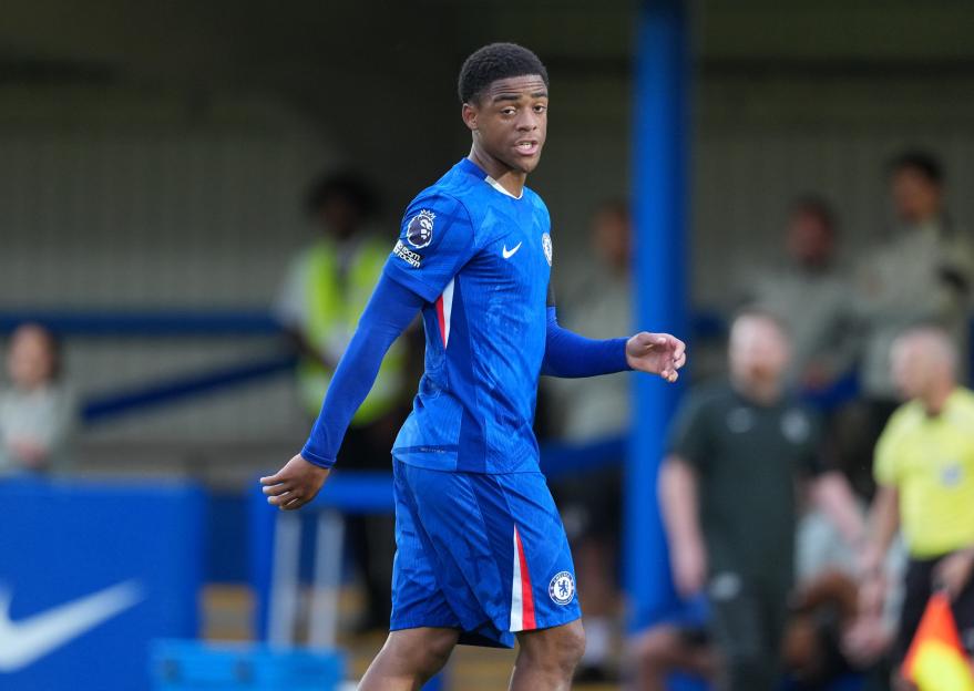 A Chelsea U21 player wearing a blue kit looks toward the field during a Premier League 2 match against Manchester City U21.