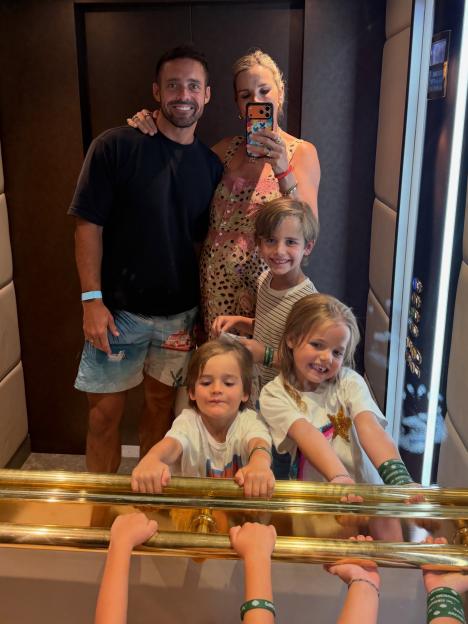 Vogue Williams taking a selfie with Spencer Matthews and their three children in an elevator.