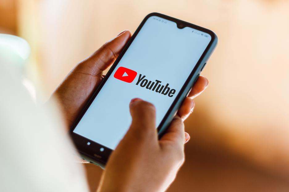 Photo illustration of the YouTube logo displayed on a smartphone.