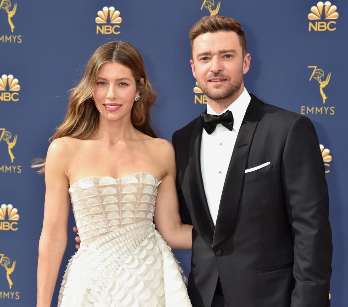 Jessica Biel in a strapless white gown and Justin Timberlake in a black tuxedo pose at the 70th Emmy Awards.