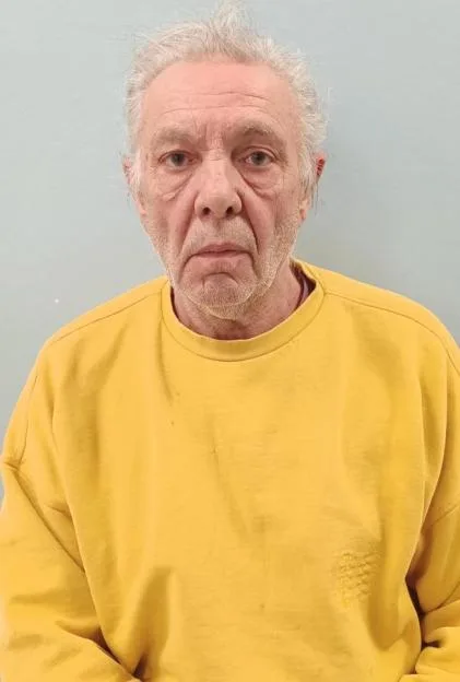 Police custody photo of Melvin West wearing a yellow sweatshirt.