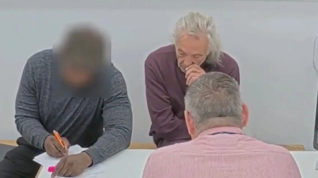 Melvin West sitting at a table with two other people.