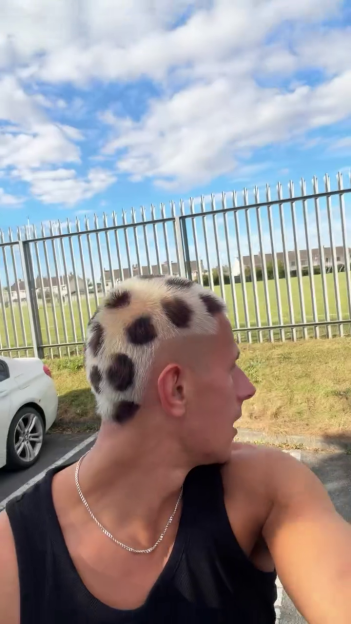 A man with a bleached haircut with dark animal print spots.