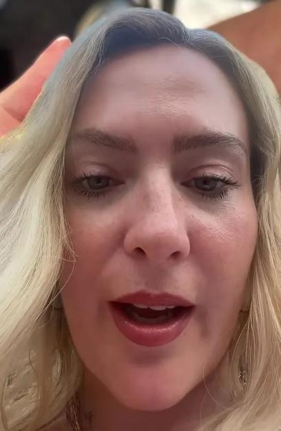 A woman with blonde hair and red lipstick looking directly at the camera.