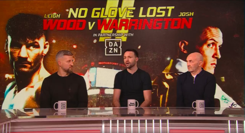 Three men sitting at a table with mugs in front of a "NO GLOVE LOST" fight promotion backdrop.