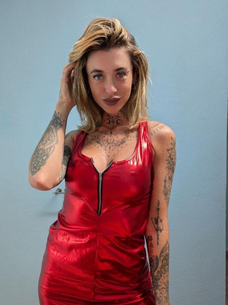 Saurora Grace in a shiny red dress.