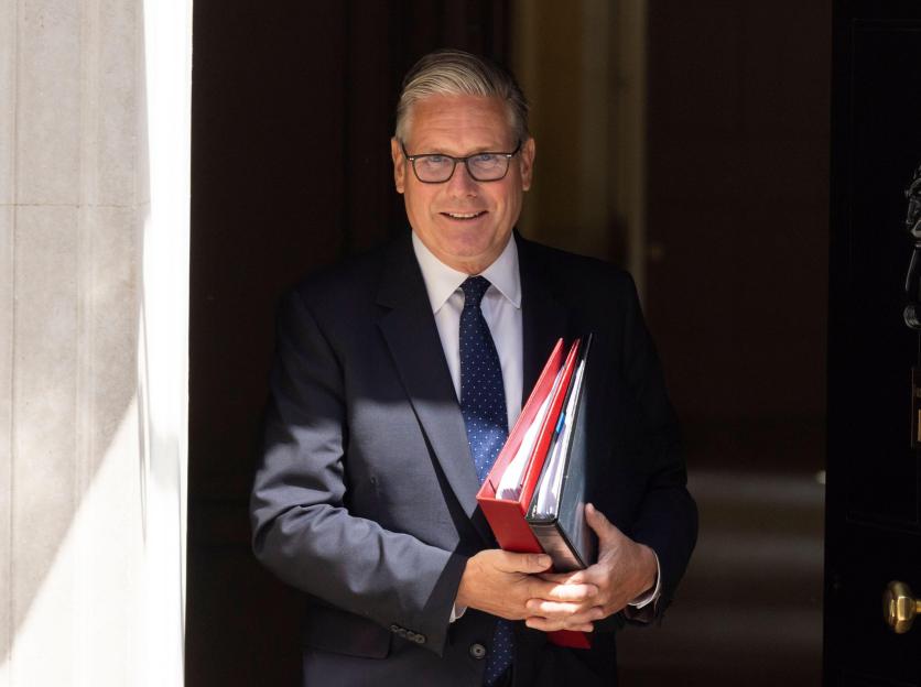 Keir Starmer, Prime Minister, leaving Number 10 Downing Street carrying two files.