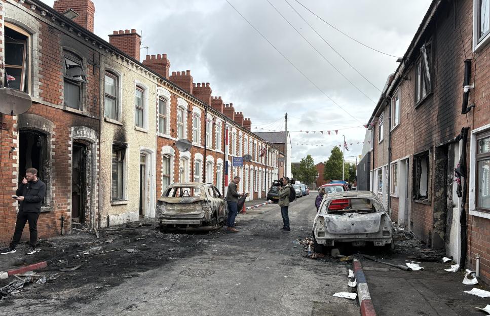 Burned-out cars and houses on Lendrick Street in Belfast after violence.