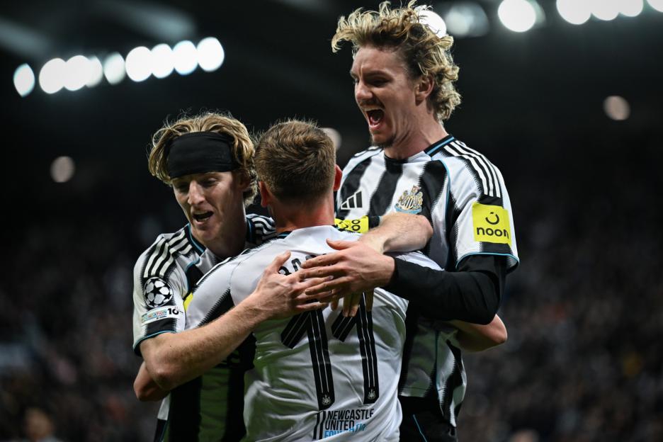 Newcastle United FC players celebrating a goal.