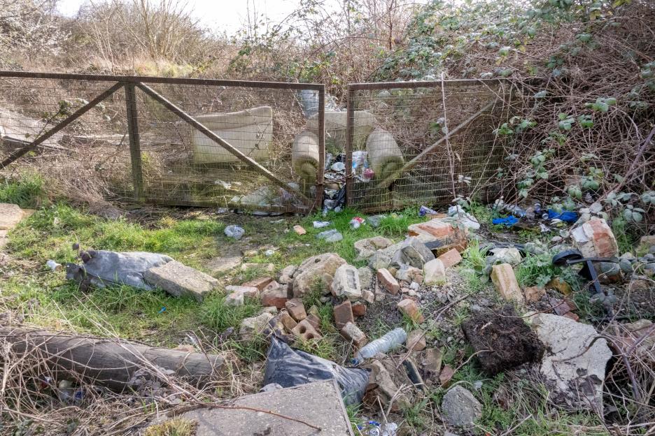 Accumulated rubbish behind a fence at a traveler site in South Ockendon.