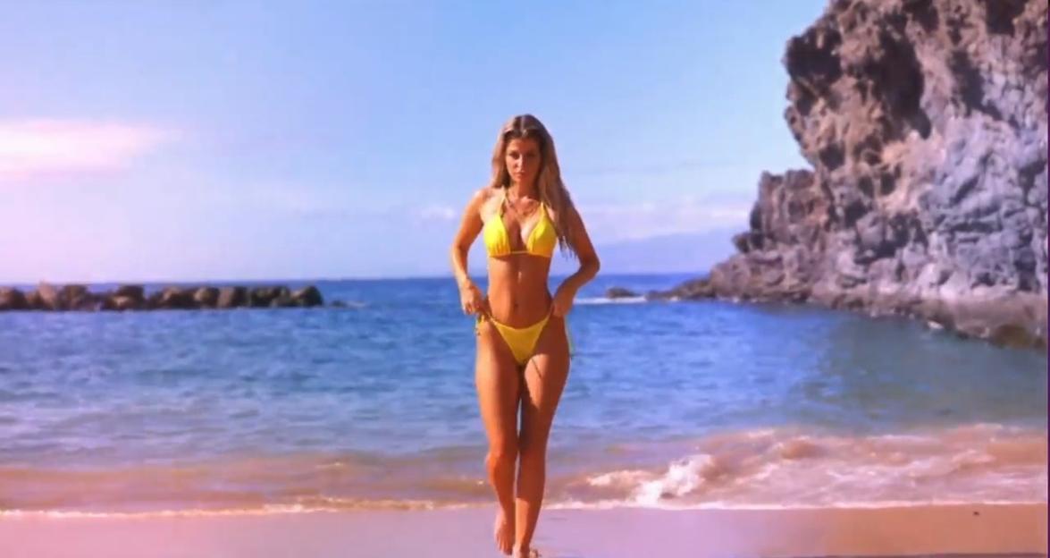 A woman in a yellow bikini on a beach.