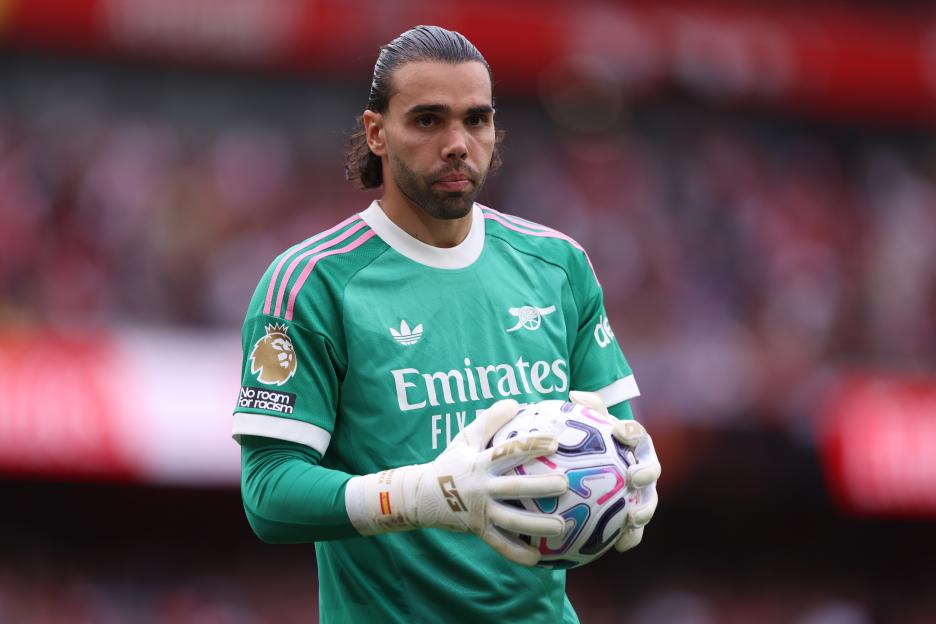 David Raya of Arsenal FC holding a soccer ball.