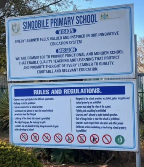 Sign detailing the vision, mission, rules, and regulations of Sinqobile Primary School.