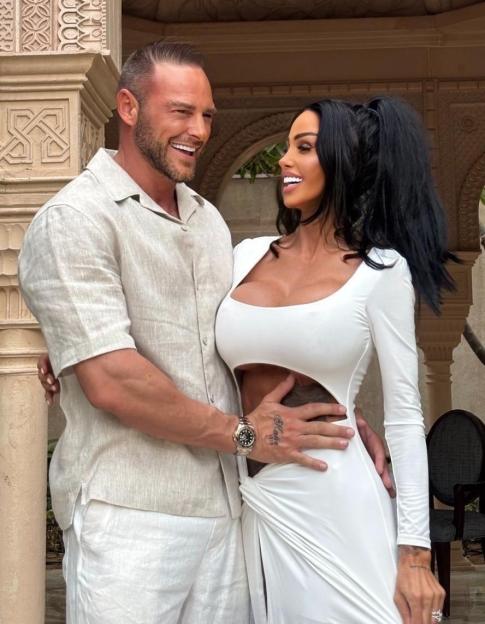 Katie Price and Lee Andrews embracing.