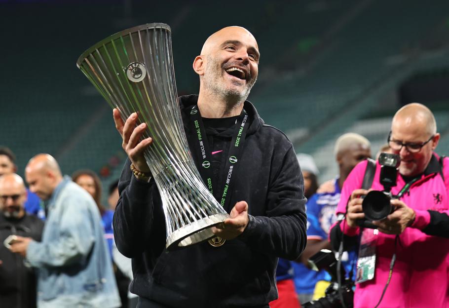 Enzo Maresca, Chelsea FC manager, celebrates holding the UEFA Conference League trophy.