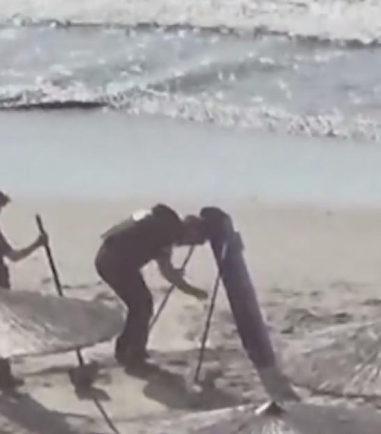 Bomb squad members pulling an explosive-laden drone out of the sea in Romania.