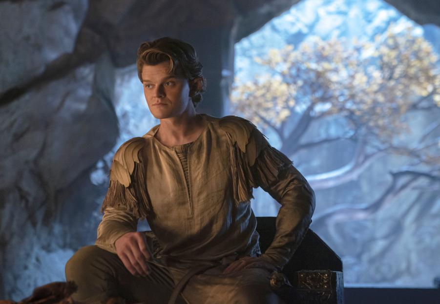 Robert Aramayo as Elrond in "The Lord of the Rings: The Rings of Power" sits dressed in elven attire.