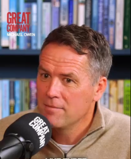 Michael Owen speaking into a microphone.