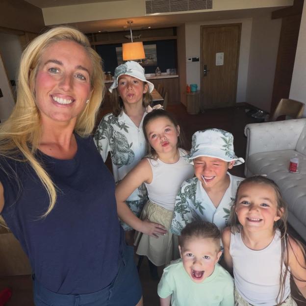 Paris Fury smiles for a family photo with her six children during a trip to Thailand.