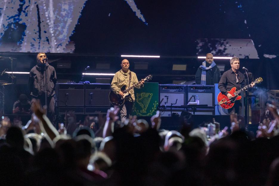 Oasis performing in concert at MetLife Stadium.