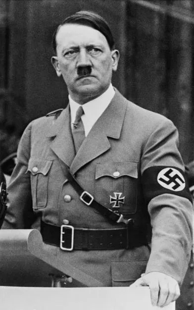 Adolf Hitler in uniform with an Iron Cross and a swastika armband.
