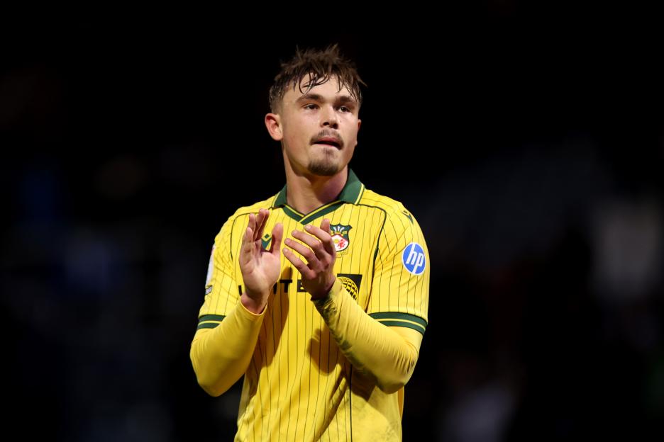 Callum Doyle of Wrexham applauding fans at full-time.
