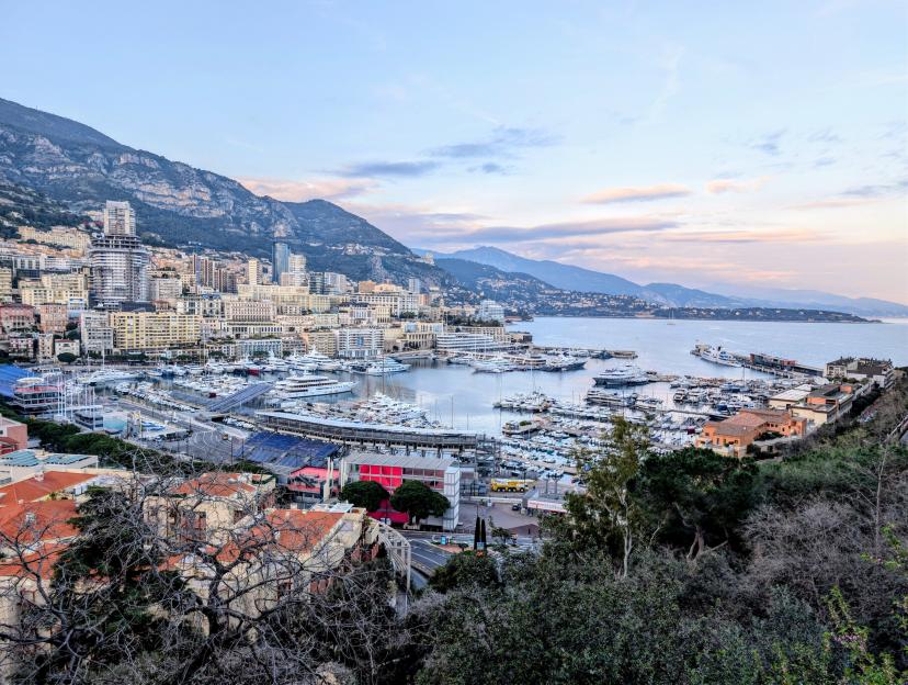 Aleksander Sikora's trip to Monaco, showing yachts in the harbor with city buildings and mountains in the background.
