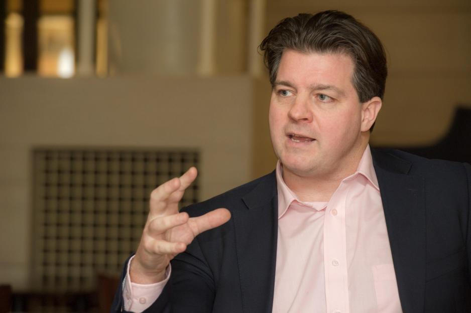 Liam Halligan, British economist, journalist, and broadcaster, speaking and gesturing with his right hand.