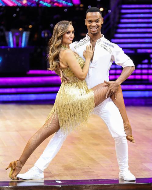 Catherine Tyldesley and Johannes Radebe posing in a dance lift at a photocall.