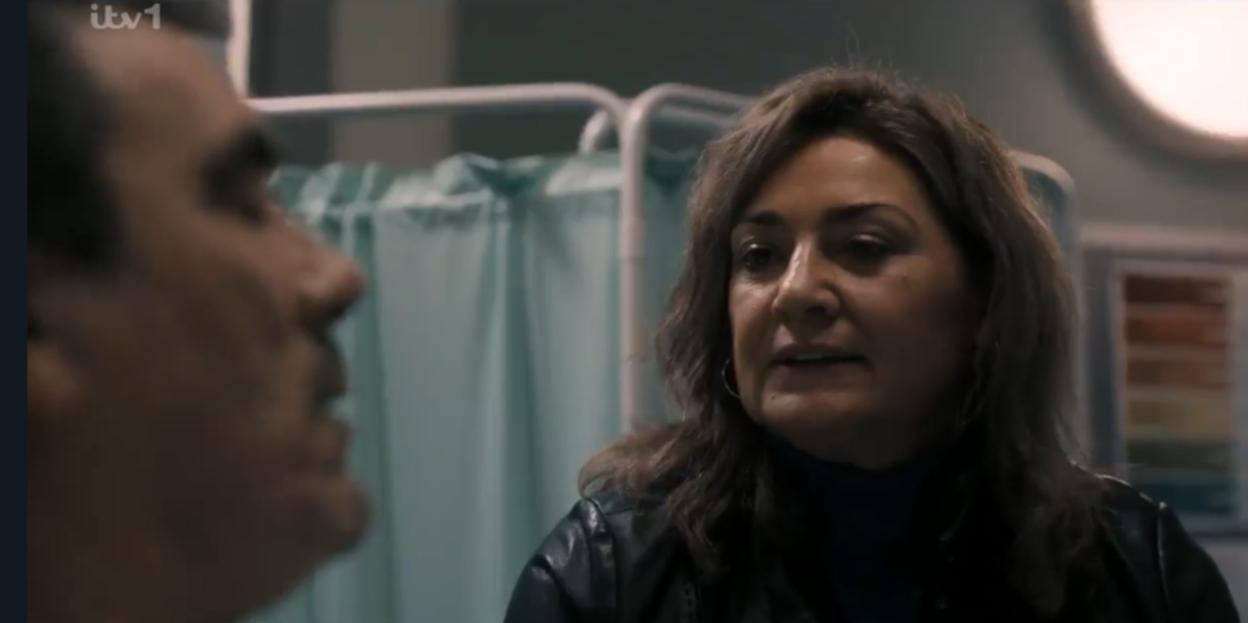 A man and woman conversing, facing each other.