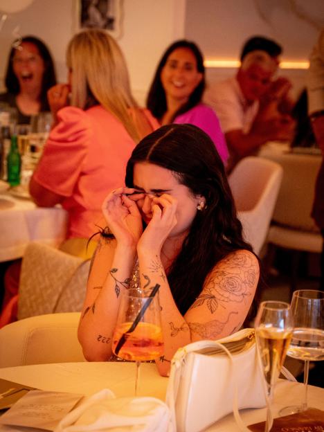 Sadie Bass covering her face while crying tears of joy.