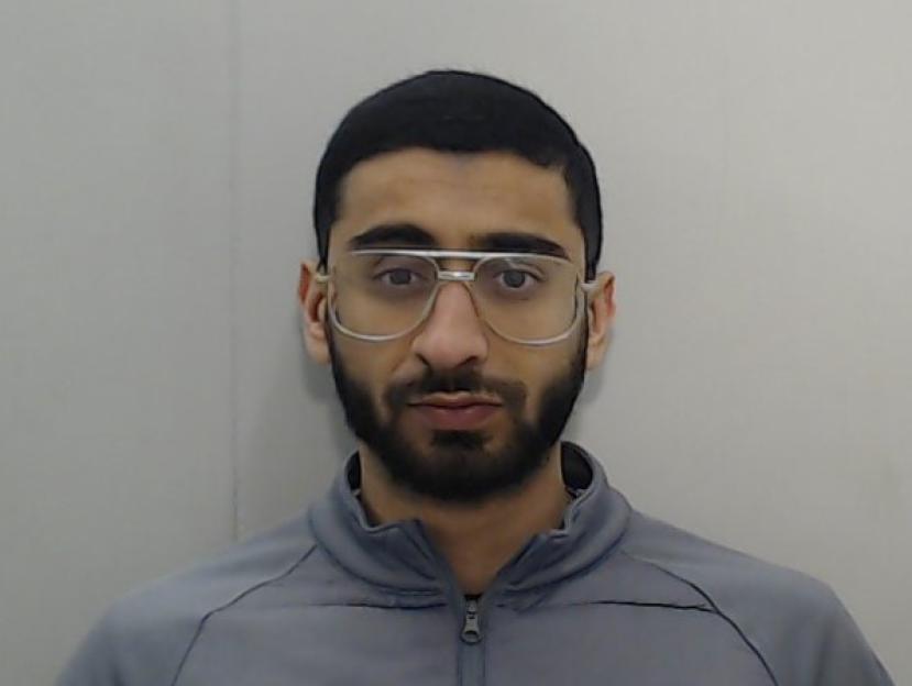 Mugshot of Rohail Jillani, a man with a beard and glasses, wearing a gray track jacket.