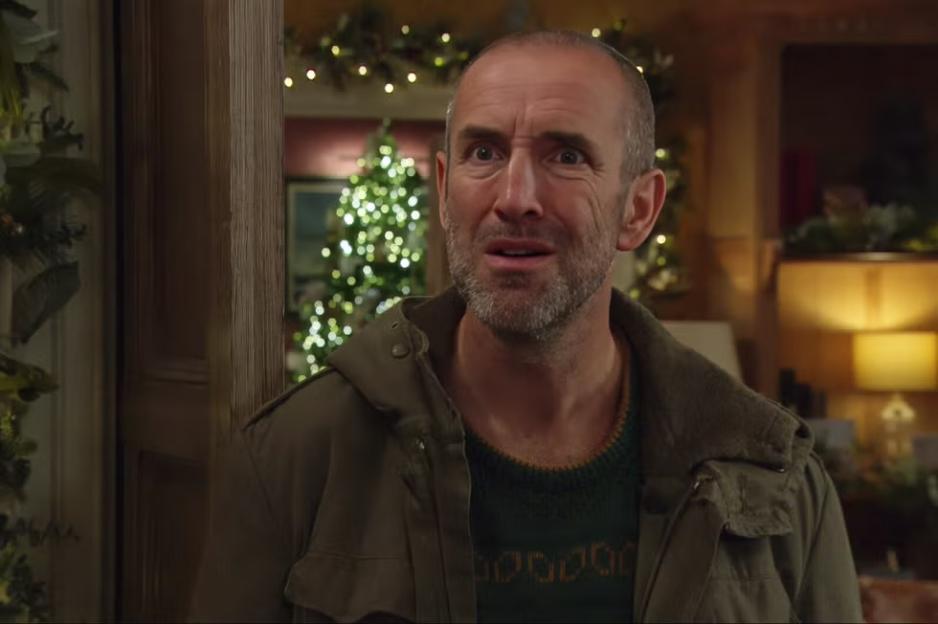 Sam Dingle looking shocked in a festive setting.