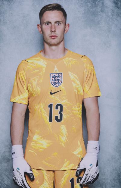 Dean Henderson in an orange England goalkeeper jersey with number 13.