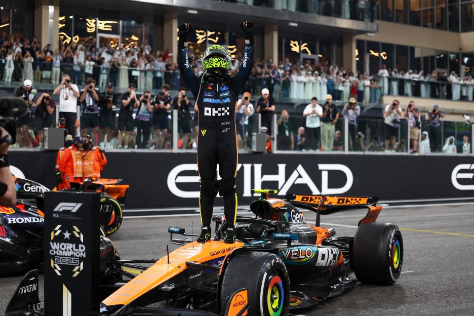 Lando Norris celebrating on top of his McLaren car at the Abu Dhabi Formula One Grand Prix.