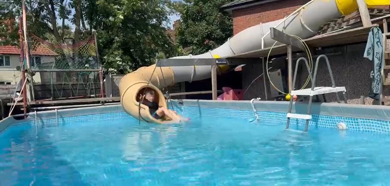 Brit dad builds own 'mini waterpark' by installing huge WATERSLIDE from garage to garden