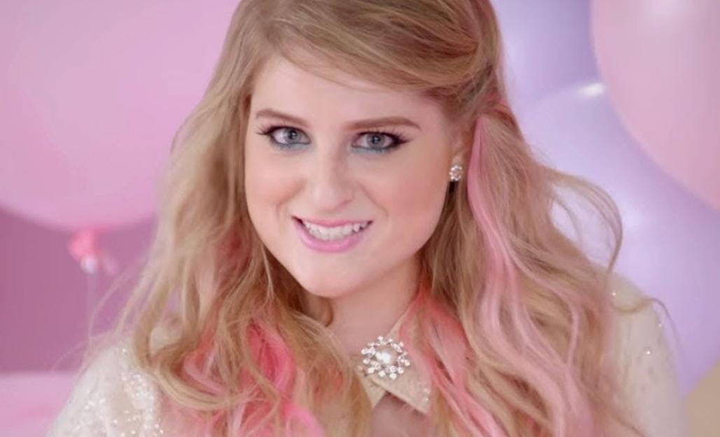 Meghan Trainor smiling in the "All About That Bass" music video.