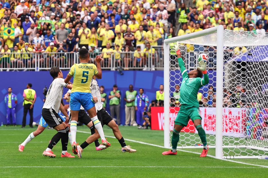 Brazil's Casemiro, wearing number 5, celebrates a goal with Neymar Jr, wearing number 10, during a soccer match.