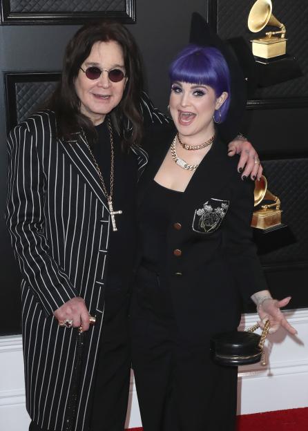 Ozzy Osbourne and Kelly Osbourne posing together on a red carpet.