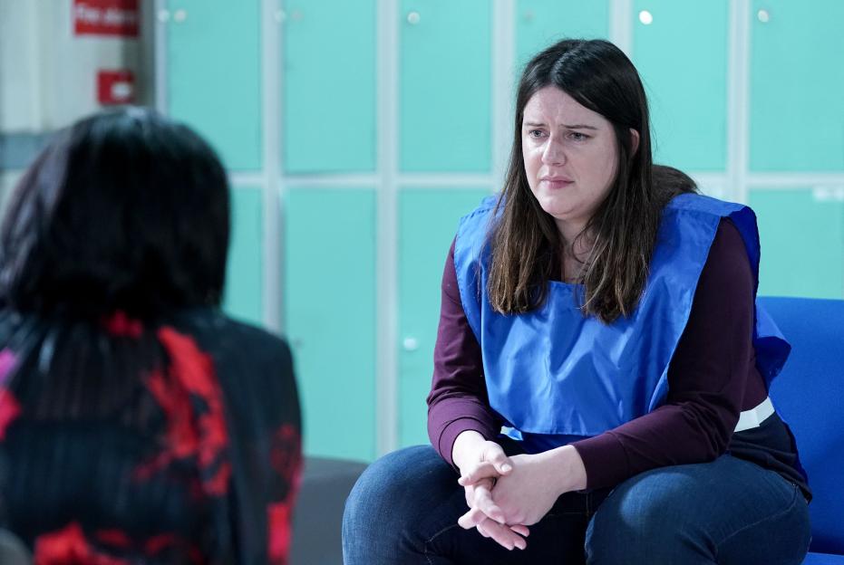 Zoe Slater (Michelle Ryan) sits opposite an unknown person.