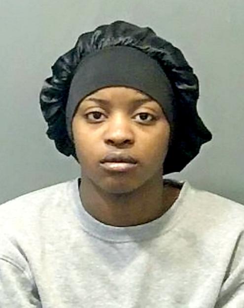 Mugshot of Temidayo Awe, wearing a black satin bonnet and grey sweatshirt.