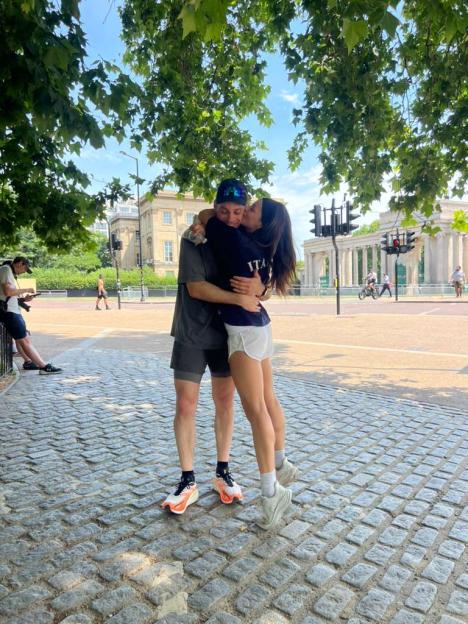 Ana Villafañe embracing her partner, kissing him on the cheek.