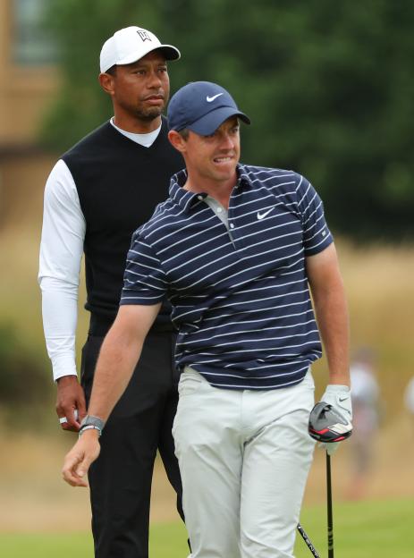 Tiger Woods and Rory McIlroy on a golf course.